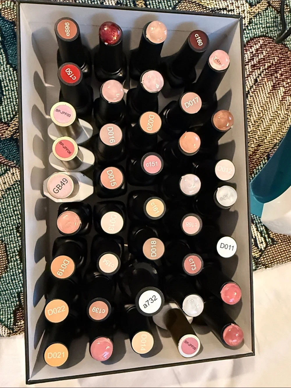 Collection of gel, nail polishes. Mostly light neutrals and dark neutrals.